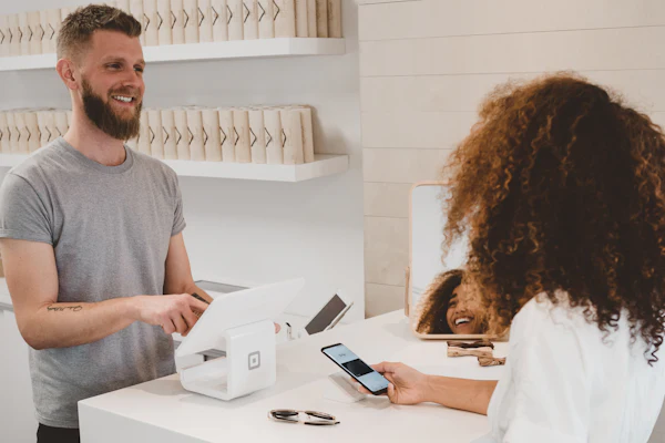 Business owner serving a customer at the counter