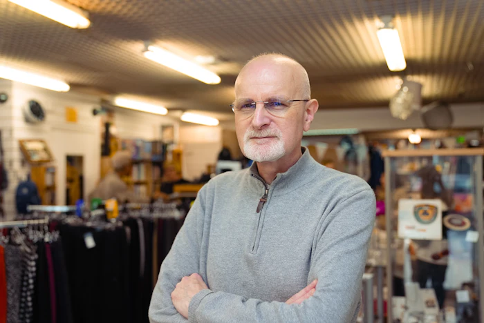 Owner of a local business standing in his shop